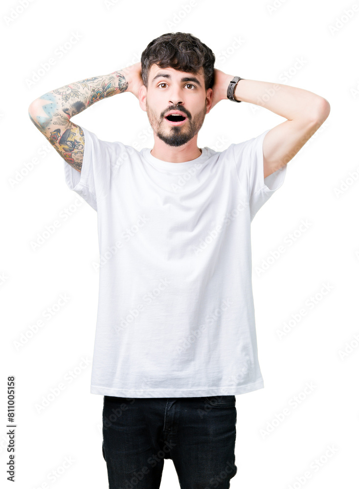 Young handsome man wearing white t-shirt over isolated background Crazy and scared with hands on head, afraid and surprised of shock with open mouth Young handsome man wearing white t-shirt over isolated background Crazy and scared with hands on head, afraid and surprised of shock with open mouth