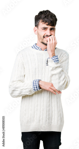 Young handsome man wearing winter sweater over isolated background looking stressed and nervous with hands on mouth biting nails. Anxiety problem.
