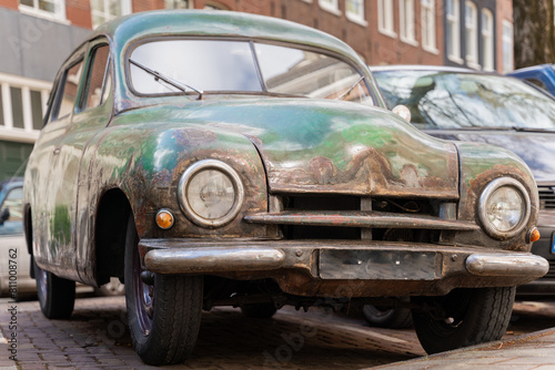 Front view of rusty oldtimer car Skoda 1200 from 1953. An old abandoned family car. © Kaja