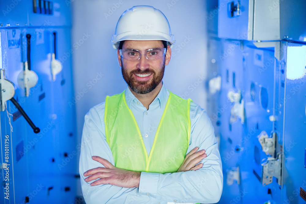 engineer heat plant or electrician worker with goggles and uniform looking at camera with folded arms engineer heat plant or electrician worker with goggles and uniform looking at camera with folded arms