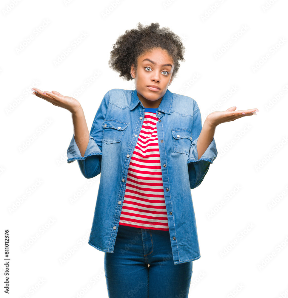 Young afro american woman over isolated background clueless and confused expression with arms and hands raised. Doubt concept. Young afro american woman over isolated background clueless and confused expression with arms and hands raised. Doubt concept.