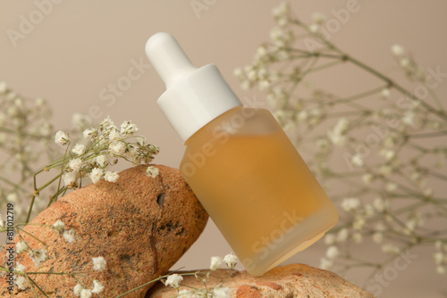 Bottle of facial serum on a light background. Facial care cosmetics