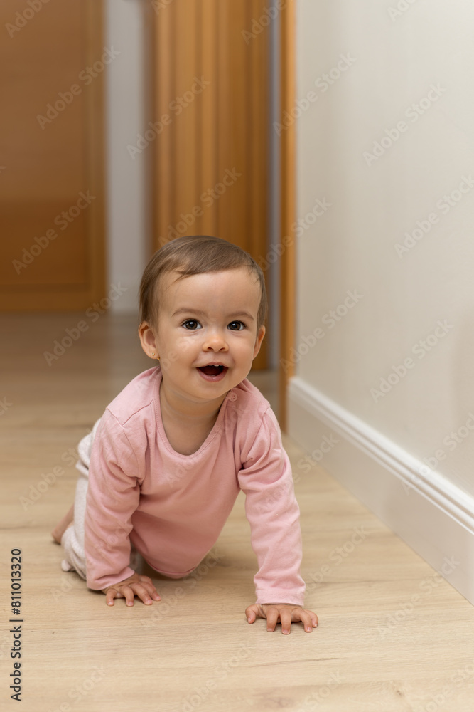 A smiling and happy baby crawls on the floor A smiling and happy baby crawls on the floor