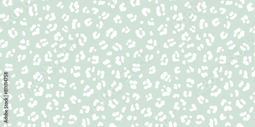 Pastel green leopard skin print seamless pattern. White cheetah spots on sage green background neutral safari print.