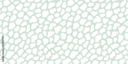 Abstract pastel sage green cow or giraffe spots seamless pattern. White organic blob shapes on a mint green background.
