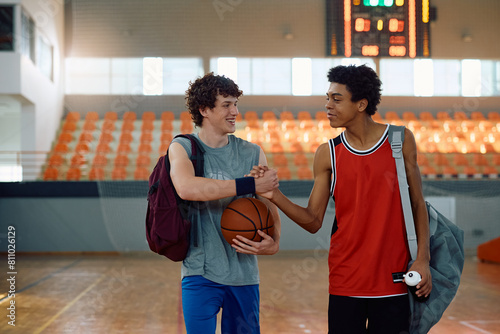 Young basketball players greeting after sports training.