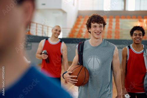Happy basketball player and his playmates coming to practice. © Drazen
