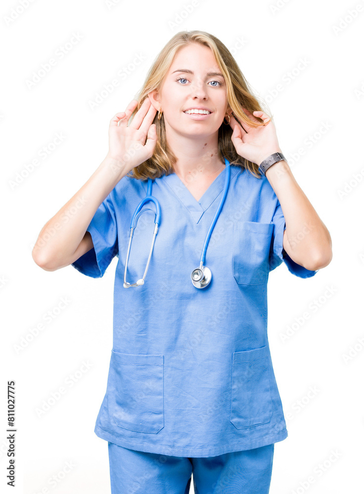 Beautiful young doctor woman wearing medical uniform over isolated background Trying to hear both hands on ear gesture, curious for gossip. Hearing problem, deaf Beautiful young doctor woman wearing medical uniform over isolated background Trying to hear both hands on ear gesture, curious for gossip. Hearing problem, deaf