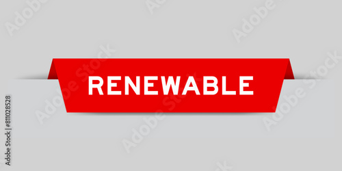 Red color inserted label with word renewable on gray background