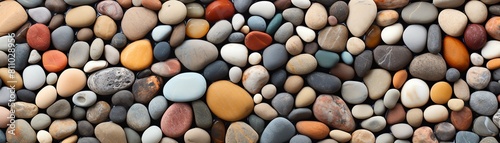 A seamless, high-resolution texture of wet beach pebbles in various colors and sizes.