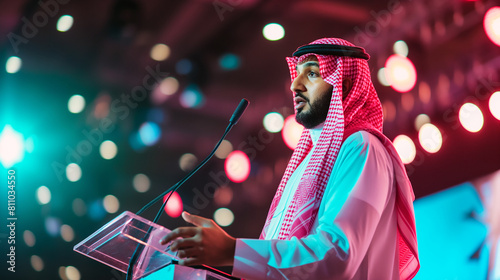 Saudi speaker at event exhibition wearing keffiyeh dish dash and Kandora photo