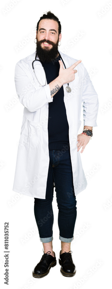 Doctor with long hair wearing medical coat and stethoscope cheerful with a smile of face pointing with hand and finger up to the side with happy and natural expression on face Doctor with long hair wearing medical coat and stethoscope cheerful with a smile of face pointing with hand and finger up to the side with happy and natural expression on face
