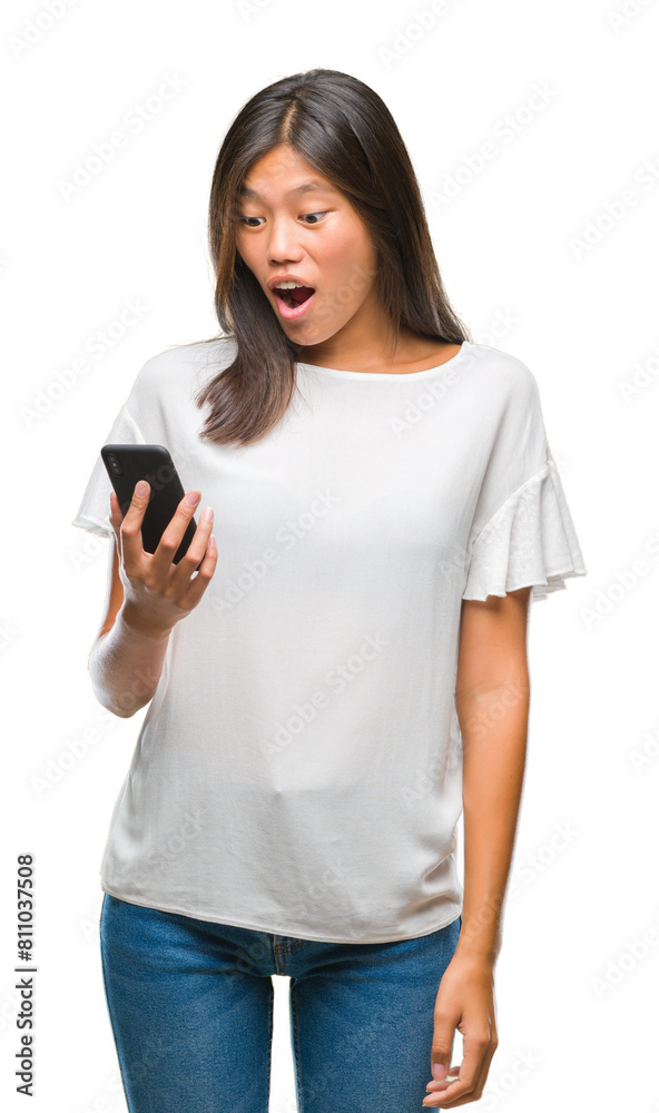 Young asian woman texting using smartphone over isolated background scared in shock with a surprise face, afraid and excited with fear expression Young asian woman texting using smartphone over isolated background scared in shock with a surprise face, afraid and excited with fear expression