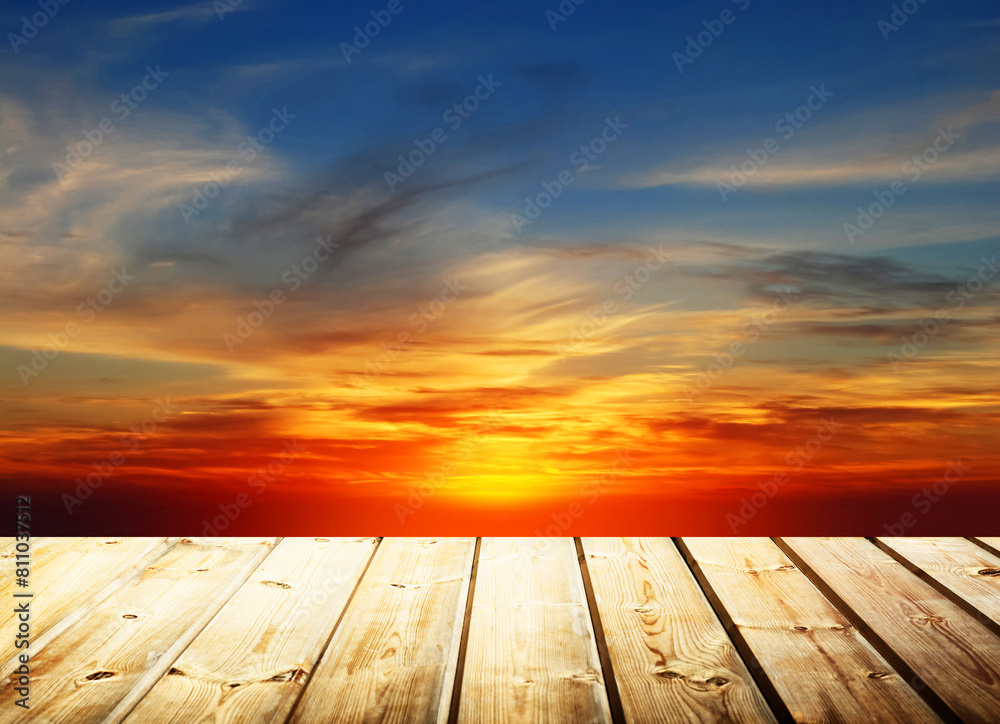 Wooden table on sky background and sunset light Wooden table on sky background and sunset light