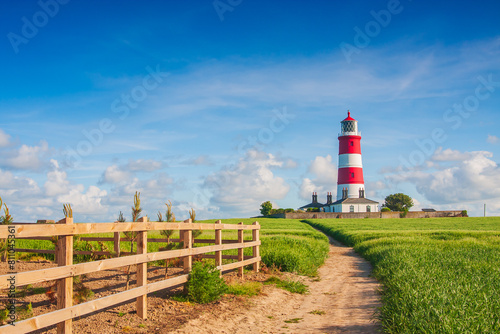 Happisburgh Lighthouse, the oldest working lighthouse on the coast in North Norfolk, UK on a sunny day
