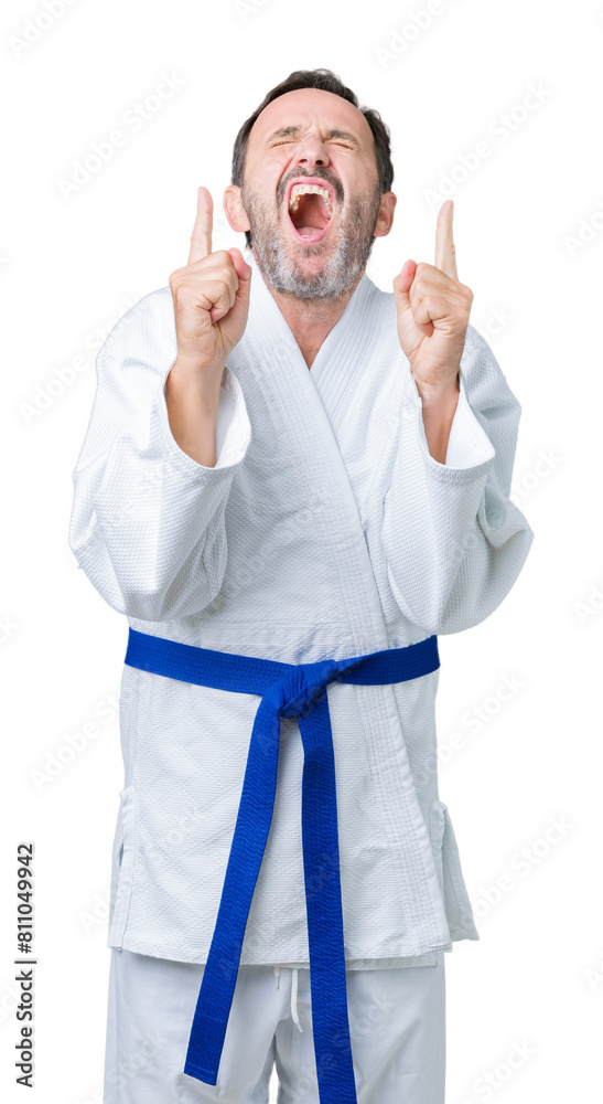 Handsome middle age senior man wearing kimono uniform over isolated background smiling crossing fingers with hope and eyes closed. Luck and superstitious concept. Handsome middle age senior man wearing kimono uniform over isolated background smiling crossing fingers with hope and eyes closed. Luck and superstitious concept.