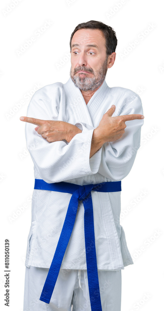 Handsome middle age senior man wearing kimono uniform over isolated background Pointing to both sides with fingers, different direction disagree Handsome middle age senior man wearing kimono uniform over isolated background Pointing to both sides with fingers, different direction disagree