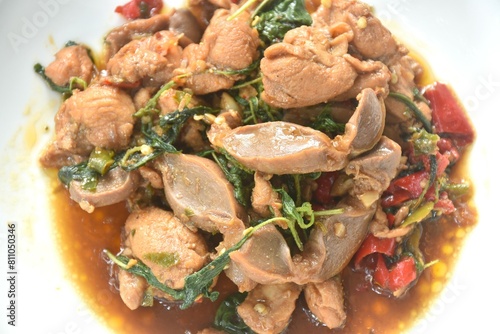spicy chili stir-fried chicken meat and gizzard couple liver with basil leaf on plate