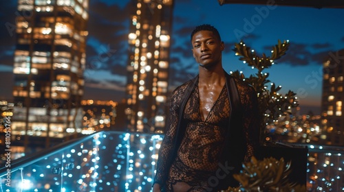 Fashionable young man in lace shirt on a rooftop at night with city lights 