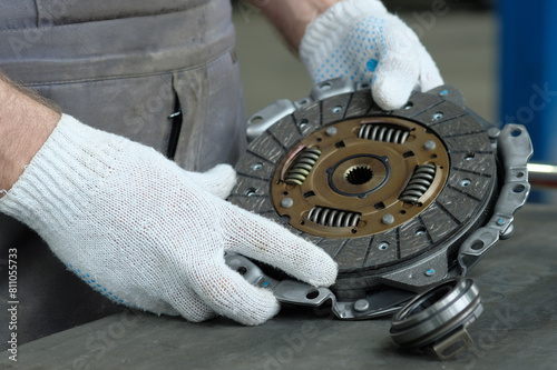 Repair of a passenger car in a car service center. An auto mechanic performs a clutch replacement.Monitoring of the technical condition of the drive, driven disc, and exhaust bearings.