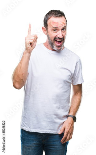 Middle age hoary senior man wearing white t-shirt over isolated background pointing finger up with successful idea. Exited and happy. Number one.