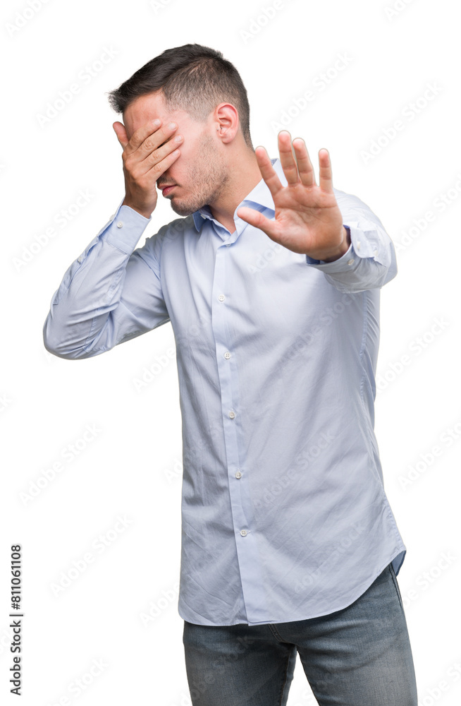 Handsome young businessman covering eyes with hands and doing stop gesture with sad and fear expression. Embarrassed and negative concept. Handsome young businessman covering eyes with hands and doing stop gesture with sad and fear expression. Embarrassed and negative concept.