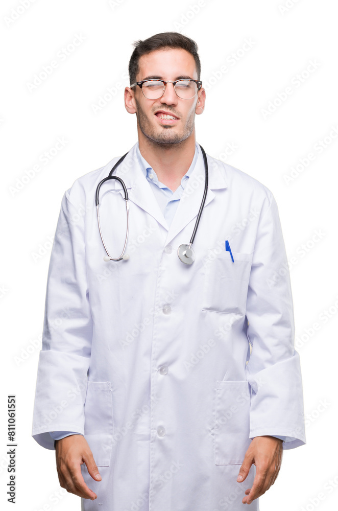 Handsome young doctor man winking looking at the camera with sexy expression, cheerful and happy face.