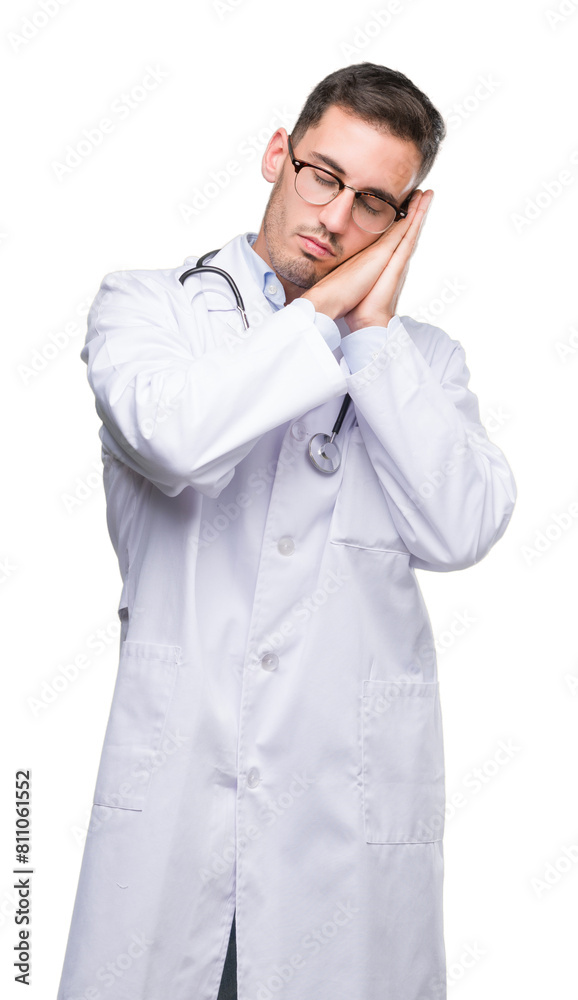 Handsome young doctor man sleeping tired dreaming and posing with hands together while smiling with closed eyes. Handsome young doctor man sleeping tired dreaming and posing with hands together while smiling with closed eyes.