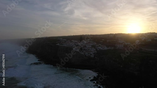 Azenhas do Mar Village in Portugal at Sunrise, Cliffs and Waves of Atlantic Ocean. Aerial View. Orbiting photo