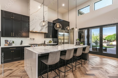 Minimalist kitchen with white herringbone tiles, black cabinets and marble island counter in an open space design with dining area