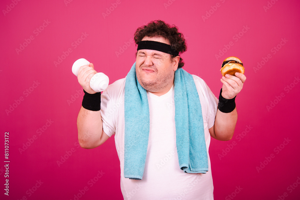 Sports nutrition and healthy lifestyle. Funny fat man and his bad habits. Pink background. Sports nutrition and healthy lifestyle. Funny fat man and his bad habits. Pink background.