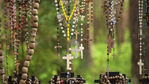 Prayer Rosaries Made of Wood Pearl Glass Hanged by Pilgrims at Christian Worship Place as Votive Offering photo