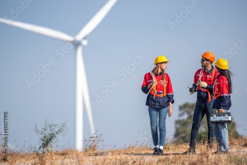 engineer team inspection check control wind power machine construction installation in wind energy factory. technician professional worker discussion check for maintenance electronic wind turbine