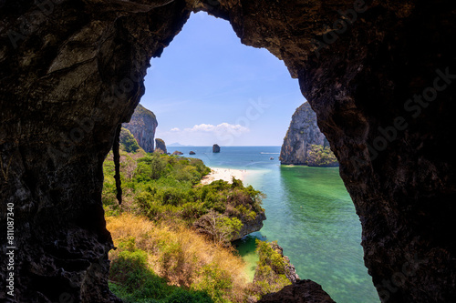 Scenic landscape of the Phranang (Phra Nang) Cave Beach and steep limestone karst cliffs on a sunny day in Railay, Krabi, Thailand, viewed from above from a cave.