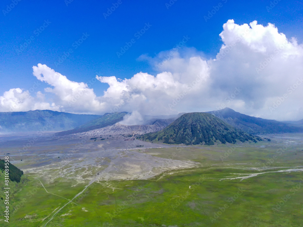 aerial view of Bromo volcano, East Java, Indonesia with smoke coming out of the crater. aerial view of Bromo volcano, East Java, Indonesia with smoke coming out of the crater.