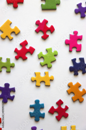 Colorful jigsaw puzzle pieces on white background. Flat lay.