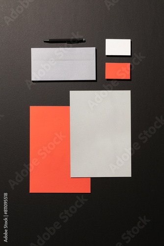 Blank corporate stationery on dark background. Mocks the brand. orange tones