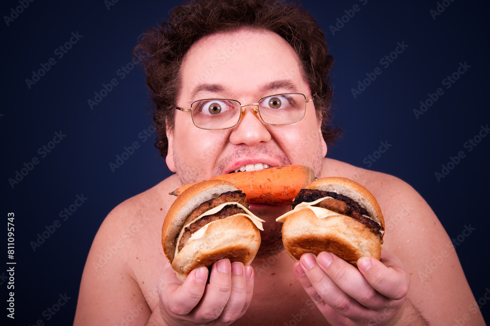Sports nutrition and healthy lifestyle. Funny fat man and his bad dieting habits. Blue background. Sports nutrition and healthy lifestyle. Funny fat man and his bad dieting habits. Blue background.