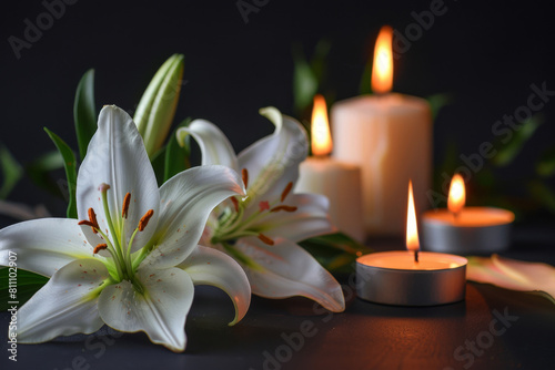 Tranquil funeral condolence background featuring white lilies and flickering candles casting warm light on a somber  dark surface