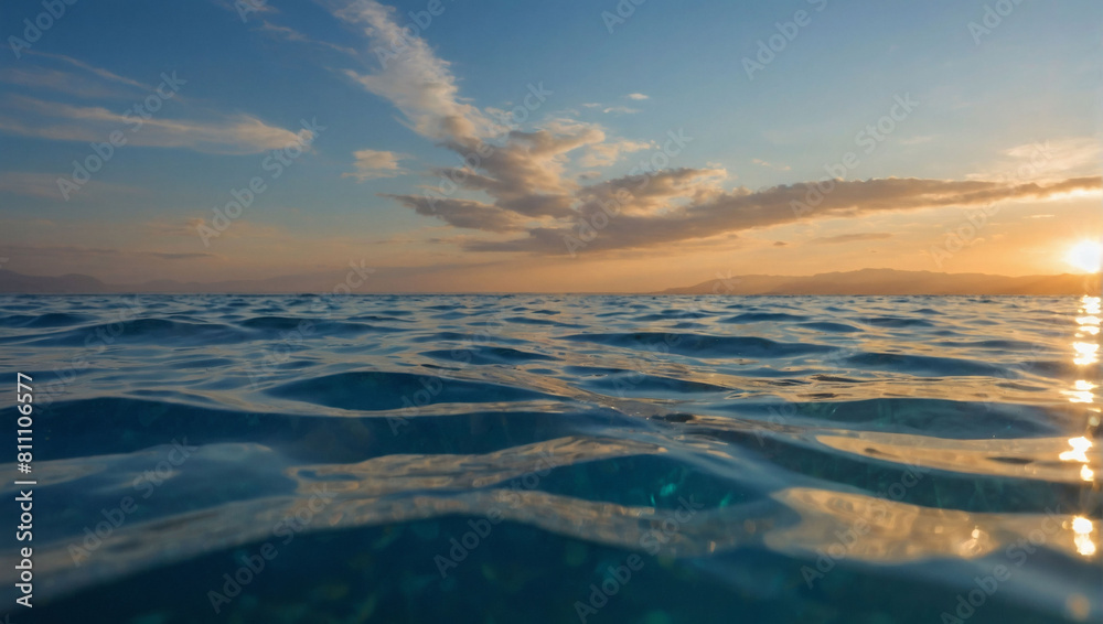 Tranquil Split View, Sunlit Sky Above and Calm Sea Below, Captured Beneath the Water's Surface Tranquil Split View, Sunlit Sky Above and Calm Sea Below, Captured Beneath the Water's Surface