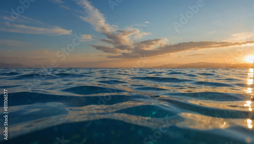 Tranquil Split View  Sunlit Sky Above and Calm Sea Below  Captured Beneath the Water s Surface