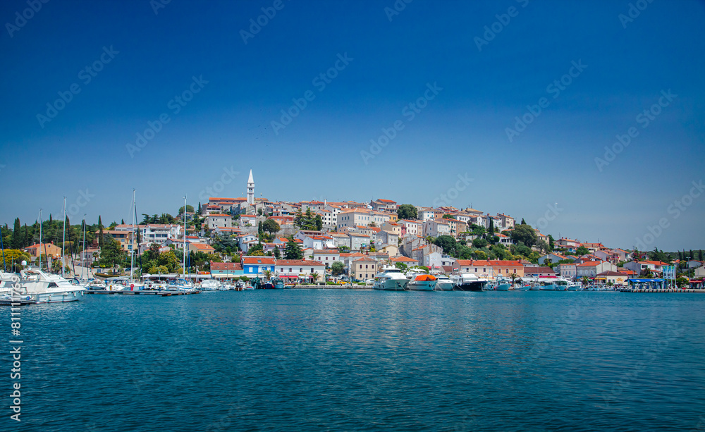 Picturesque coastal Croatia, Rovinj town viewed from water, featuring traditional architecture Picturesque coastal Croatia, Rovinj town viewed from water, featuring traditional architecture