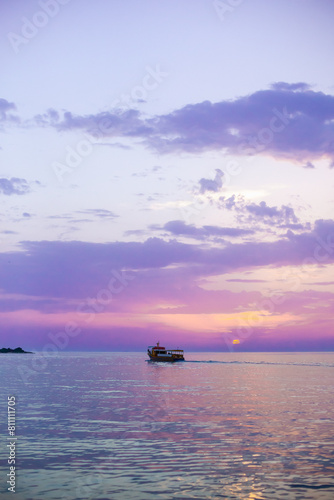 Beautiful sunset over calm sea, with vivid colors and clouds in the sky. Serenity and nature concept