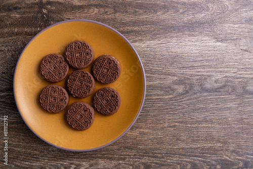 Cream-filled chocolate biscuits on a plate