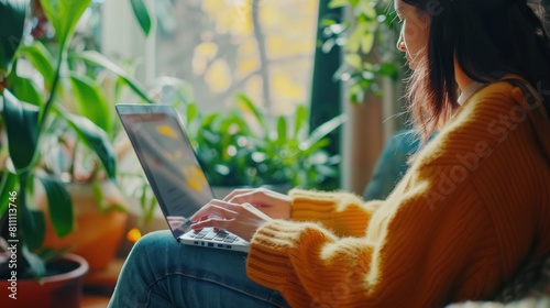 A woman typing on her laptop at a cozy home office, managing her online store and handling customer inquiries remotely