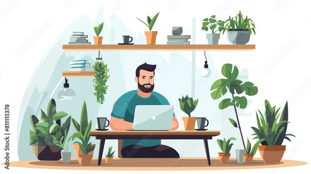 Fototapeta premium A bearded man sitting at a desk in a home office, surrounded by plants. He is wearing a green shirt and black pants, and is working on his laptop. There are two cups of coffee and a book on the desk.