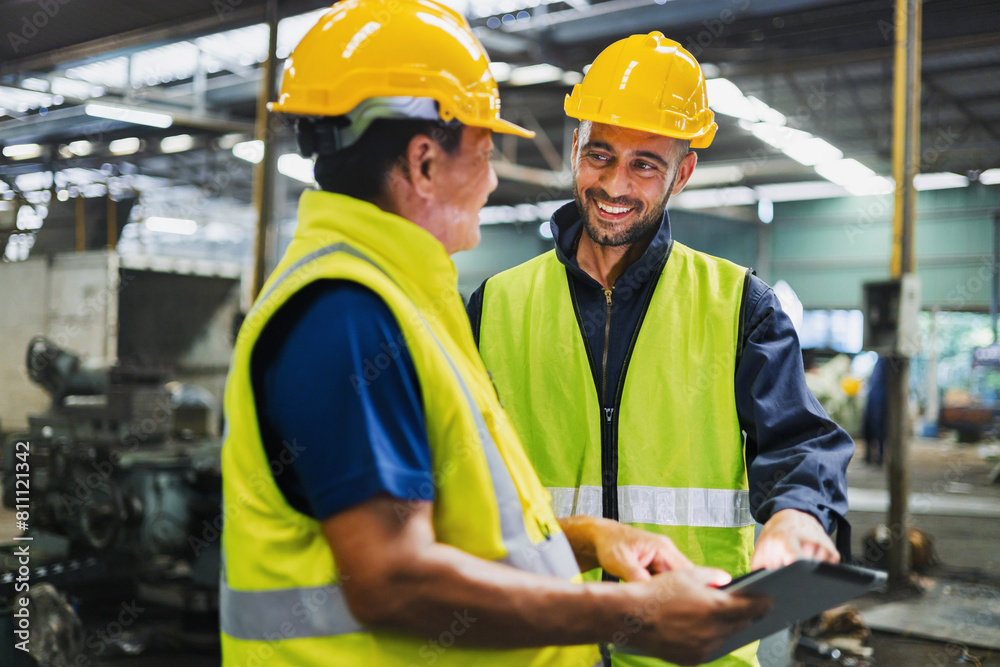 Two men in safety gear are talking to each other