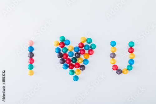 ludo tokens forming the word "I heart U" on white background