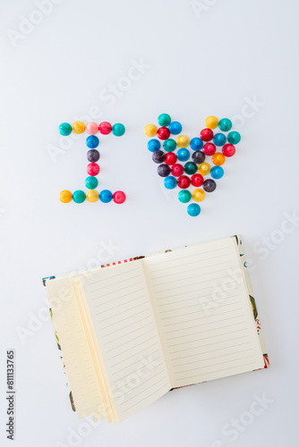 ludo tokens forming the word "I heart" and an  open empty lined notebook for mockup on white background