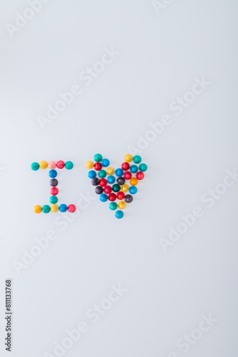 ludo tokens forming the word "I heart" on white background